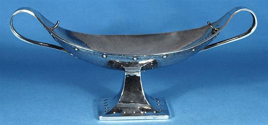 A George V Arts & Crafts silver navette shaped two handled dish, by Albert Edward Jones, Width 12 ¾”/320mm Weight: 18.3oz/520grms